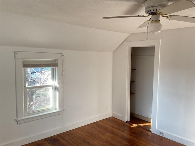 bonus room featuring a textured ceiling, ceiling fan, dark hardwood / wood-style flooring, and vaulted ceiling