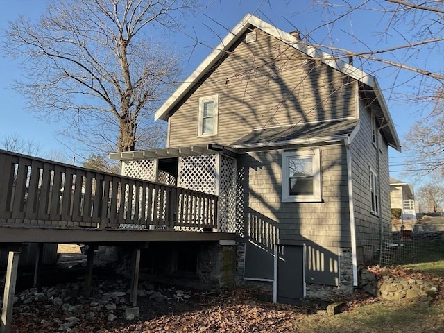 back of property featuring a wooden deck