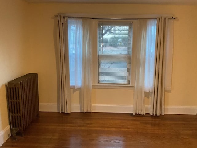 56 Riverview St, Dedham, MA 02026 - empty room featuring radiator, wood finished floors, and baseboards