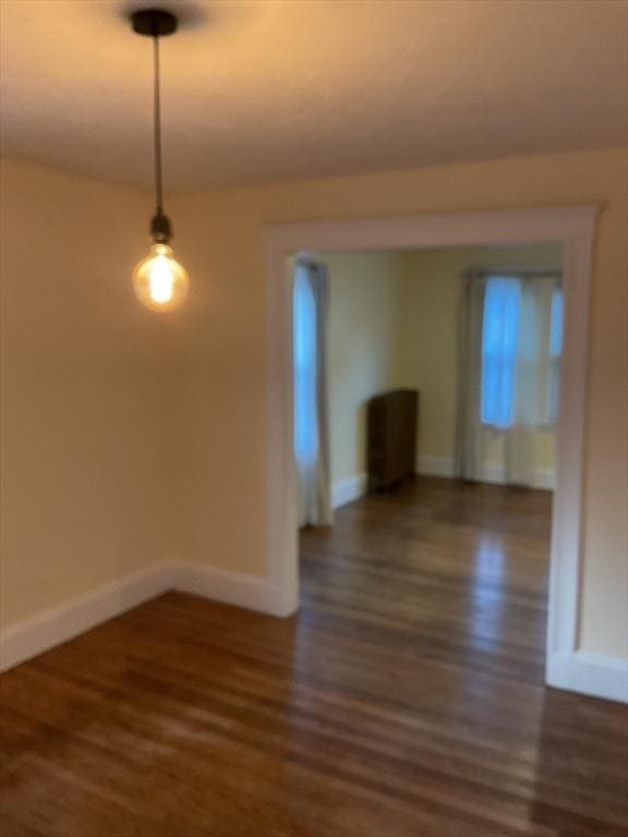 spare room with dark wood-type flooring