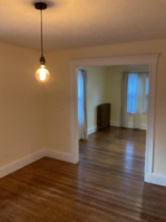 56 Riverview St, Dedham, MA 02026 - unfurnished dining area featuring wood finished floors and baseboards