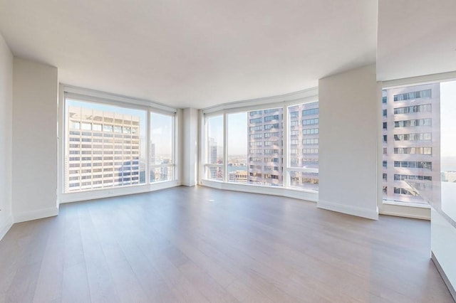 240 Devonshire St Unit 4012, Boston, MA 02110 - spare room featuring wood finished floors, healthy amount of natural light, and a city view