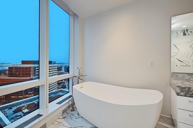 240 Devonshire St Unit 4012, Boston, MA 02110 - full bath with marble look tiles, a freestanding bath, and a city view
