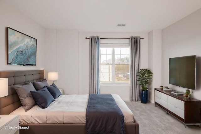 bedroom featuring light carpet