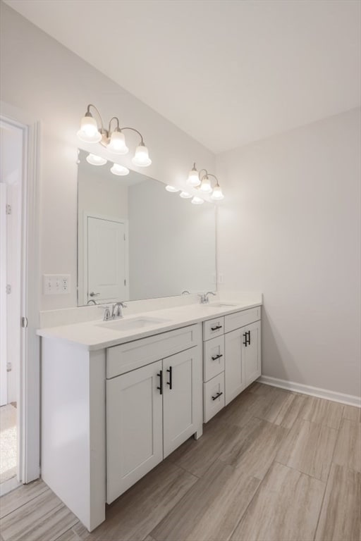 bathroom with vanity and hardwood / wood-style flooring