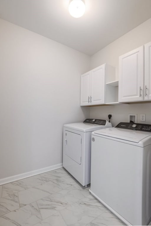 laundry room featuring cabinets and washing machine and dryer