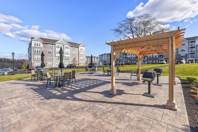 view of property's community featuring a pergola and a yard