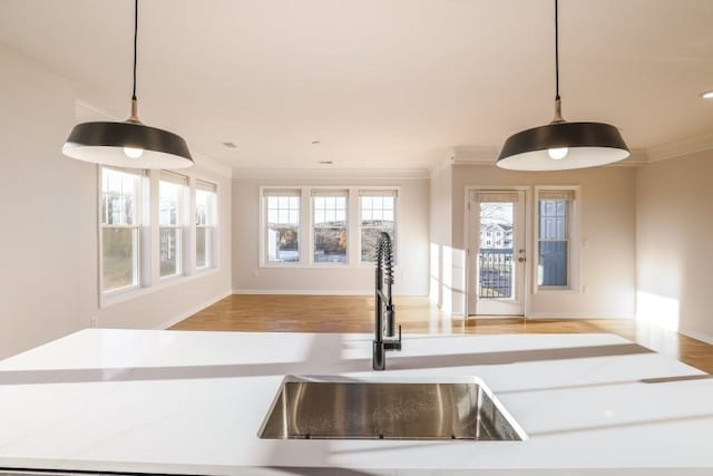 kitchen featuring a wealth of natural light, sink, and decorative light fixtures