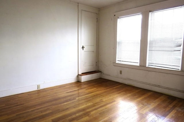 empty room featuring light wood finished floors and baseboards