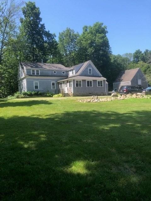 84 Booth Hill Rd, Scituate, MA 02066 - back of property with a lawn and view of wooded area