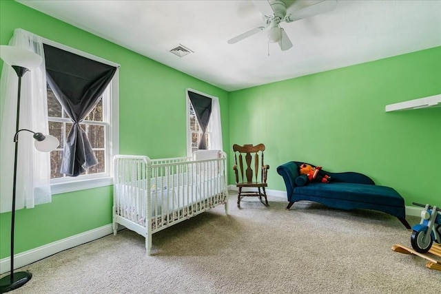 carpeted bedroom featuring ceiling fan and multiple windows