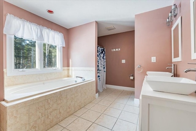 bathroom with vanity, tiled bath, and tile patterned floors