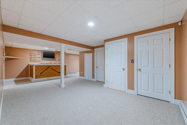 basement featuring a baseboard radiator and carpet flooring