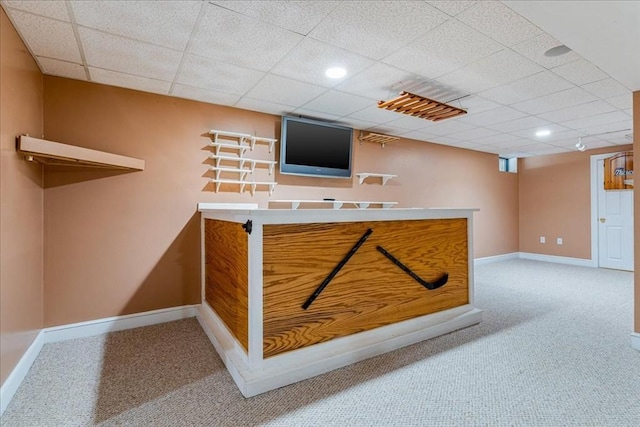 bar featuring a paneled ceiling and carpet flooring