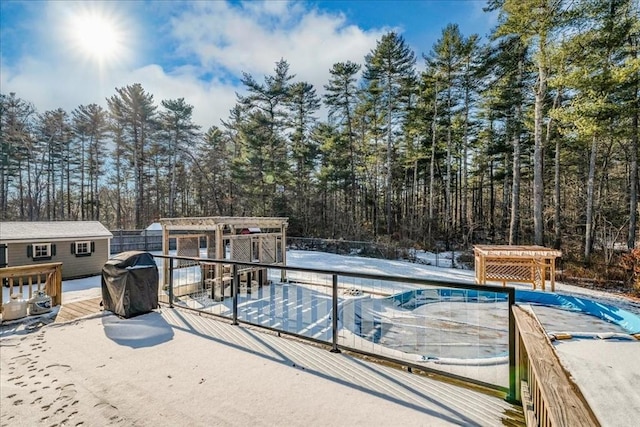 view of swimming pool featuring area for grilling and an outdoor structure