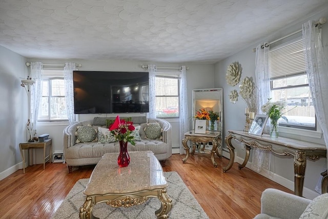 living area featuring light wood-style flooring and baseboards