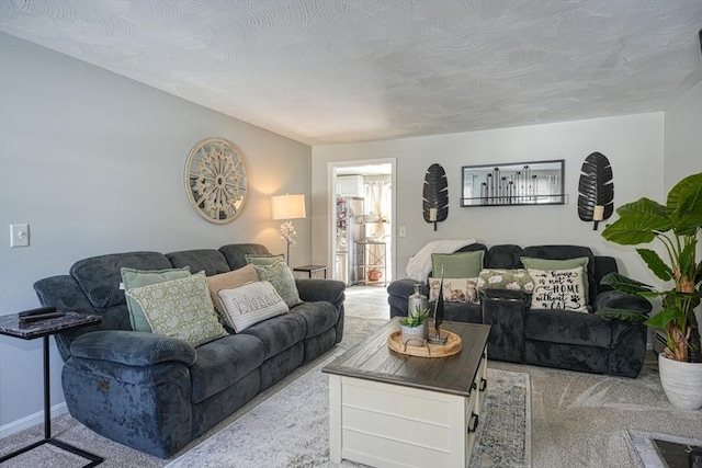 living room featuring baseboards and light colored carpet