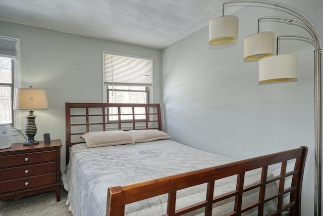 bedroom with light colored carpet