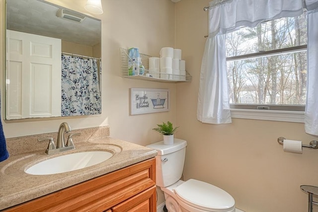 bathroom with vanity and toilet