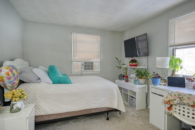 bedroom featuring light carpet and cooling unit