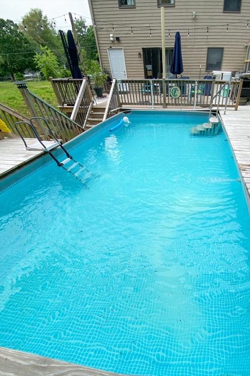 view of swimming pool with a wooden deck