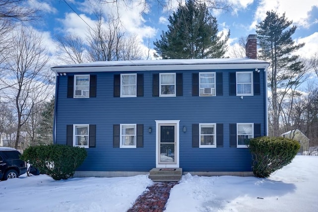 colonial home featuring a chimney