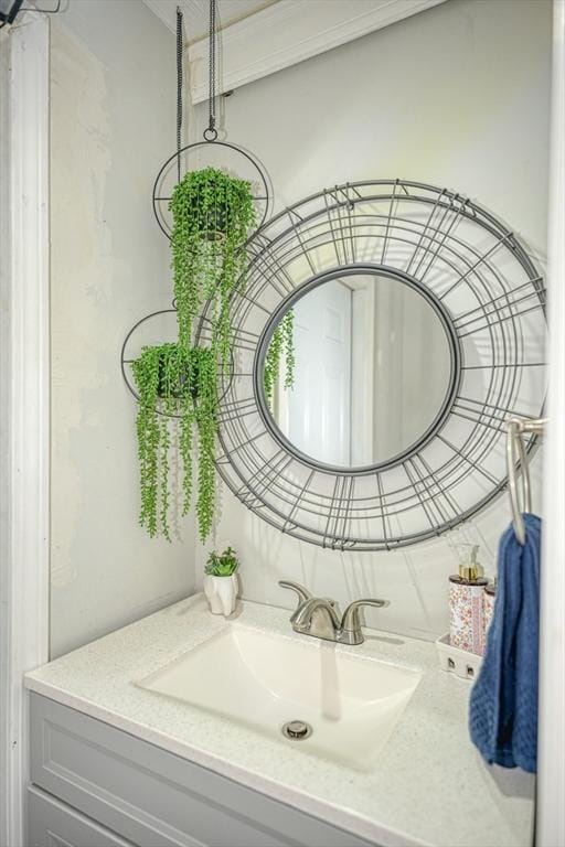 bathroom featuring crown molding and vanity