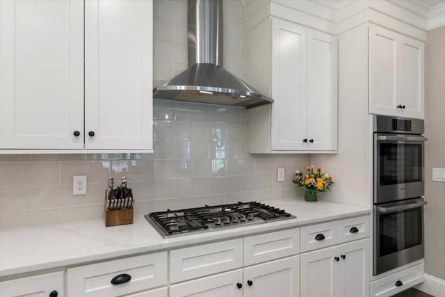21 Bailey Pond Ln Unit 21, Amesbury, MA 01913 - kitchen with appliances with stainless steel finishes, wall chimney range hood, decorative backsplash, and white cabinetry