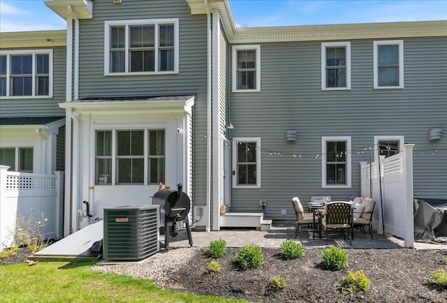 21 Bailey Pond Ln Unit 21, Amesbury, MA 01913 - rear view of house with central AC, fence, and a patio area