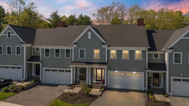 21 Bailey Pond Ln Unit 21, Amesbury, MA 01913 - view of front facade with an attached garage, a chimney, and driveway