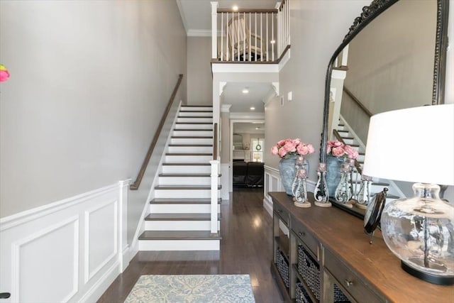 21 Bailey Pond Ln Unit 21, Amesbury, MA 01913 - stairway featuring crown molding, wood finished floors, wainscoting, a high ceiling, and a decorative wall