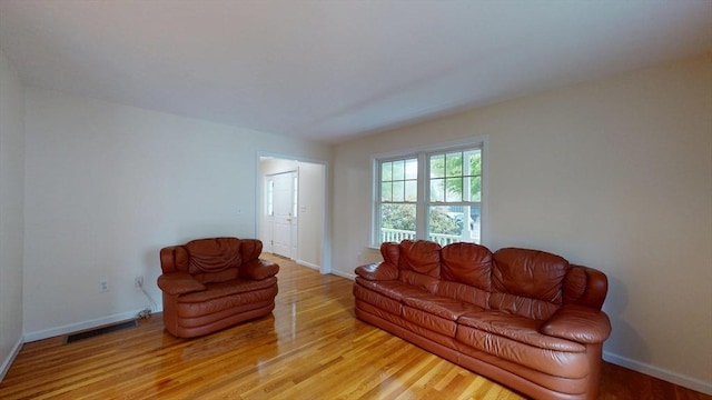 living room with light wood-style flooring and baseboards