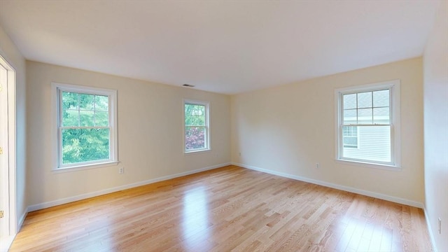unfurnished room with light wood-style floors and baseboards