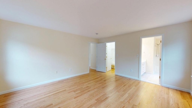 unfurnished room featuring light wood-style floors and baseboards