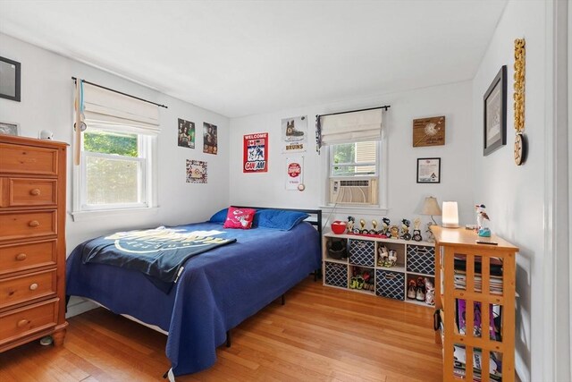 2 Woodbrier Rd, Topsfield, MA 01983 - bedroom with multiple windows, light wood-style flooring, and cooling unit