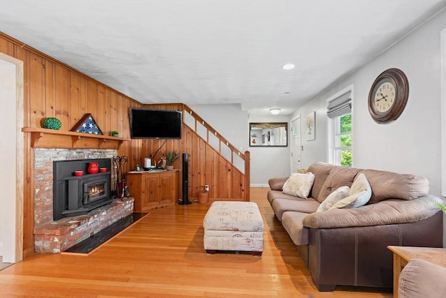 2 Woodbrier Rd, Topsfield, MA 01983 - living area with stairway, light wood-type flooring, wood walls, recessed lighting, and a wood stove
