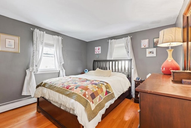 2 Woodbrier Rd, Topsfield, MA 01983 - bedroom with light wood-style floors and a baseboard radiator