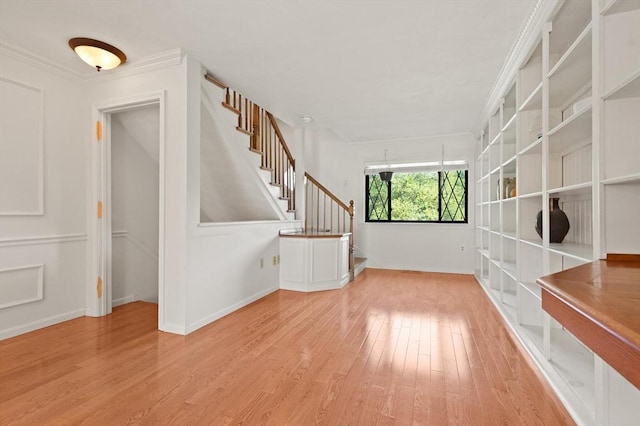 246 Farrwood Dr Unit 246, Haverhill, MA 01835 - unfurnished room featuring stairway, light wood-style floors, and ornamental molding