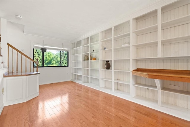 246 Farrwood Dr Unit 246, Haverhill, MA 01835 - empty room with wood finished floors, stairs, a smoke detector, crown molding, and built in shelves