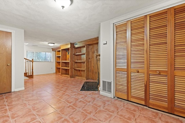 246 Farrwood Dr Unit 246, Haverhill, MA 01835 - unfurnished living room with a textured ceiling and light tile patterned flooring