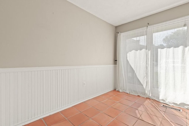 246 Farrwood Dr Unit 246, Haverhill, MA 01835 - tiled empty room with a wainscoted wall