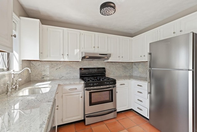 246 Farrwood Dr Unit 246, Haverhill, MA 01835 - kitchen featuring appliances with stainless steel finishes, under cabinet range hood, white cabinets, light stone counters, and backsplash