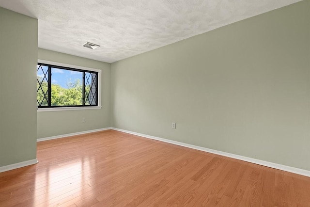 246 Farrwood Dr Unit 246, Haverhill, MA 01835 - unfurnished room with wood finished floors and a textured ceiling
