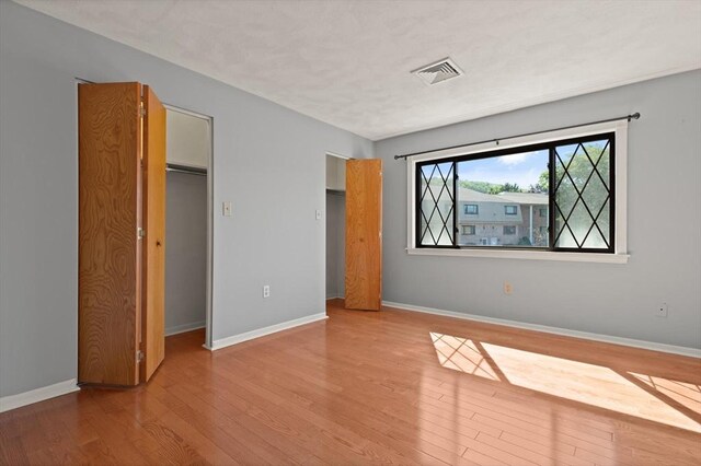 246 Farrwood Dr Unit 246, Haverhill, MA 01835 - unfurnished bedroom featuring wood finished floors, a closet, and a spacious closet