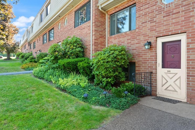 246 Farrwood Dr Unit 246, Haverhill, MA 01835 - property entrance with a yard and brick siding
