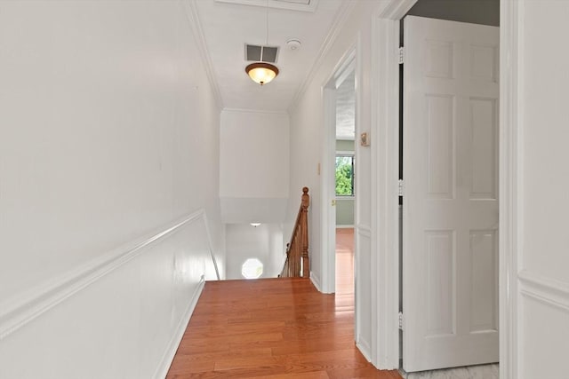 246 Farrwood Dr Unit 246, Haverhill, MA 01835 - hallway with an upstairs landing, ornamental molding, attic access, light wood-style floors, and a wainscoted wall