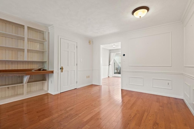 246 Farrwood Dr Unit 246, Haverhill, MA 01835 - empty room with wood finished floors, ornamental molding, and a decorative wall