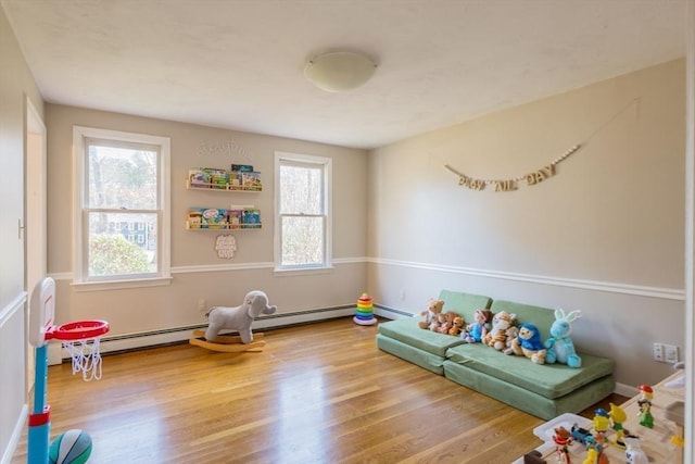 rec room with baseboards and wood finished floors