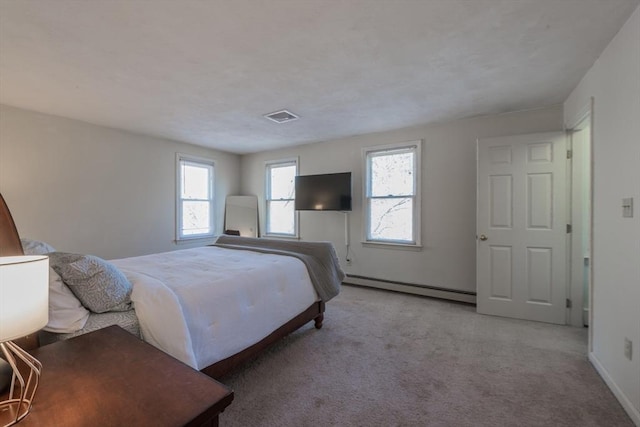 carpeted bedroom featuring visible vents, baseboards, and a baseboard radiator