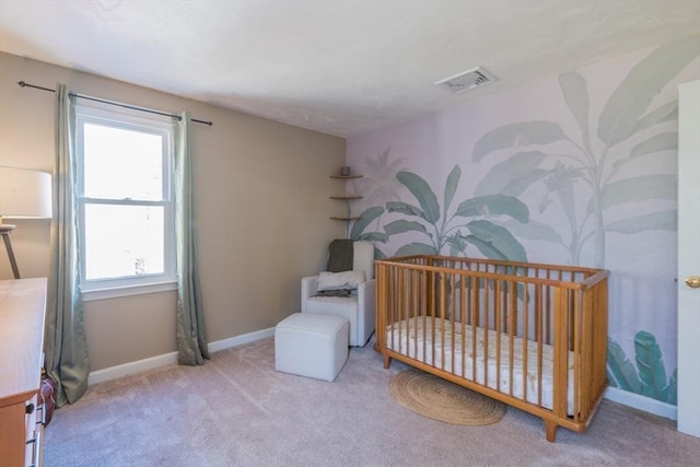 carpeted bedroom with visible vents, baseboards, and a nursery area